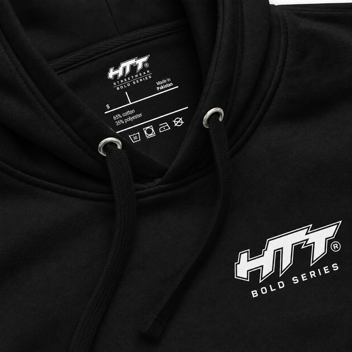 Close-up detail of HTT Bold Series No Signal black hoodie chest logo, hood and inner label