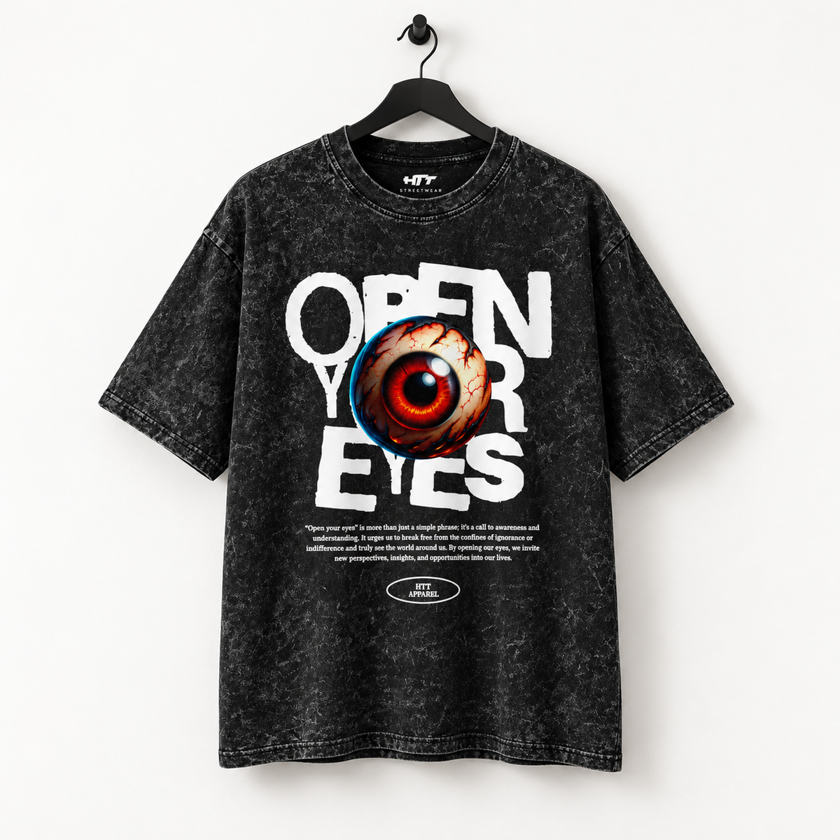 Voorkant van het HTT Open Your Eyes T-shirt in washed black aan een zwarte hanger, met witte tekstprint en rood oog op een lichte achtergrond.