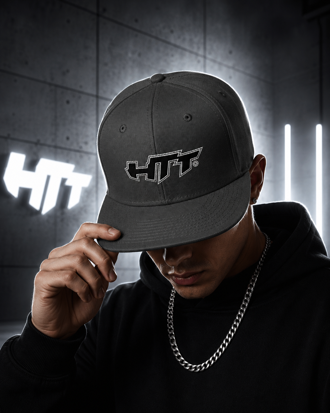 HTT Signature Snapback charcoal gray worn by male model with illuminated embroidered logo