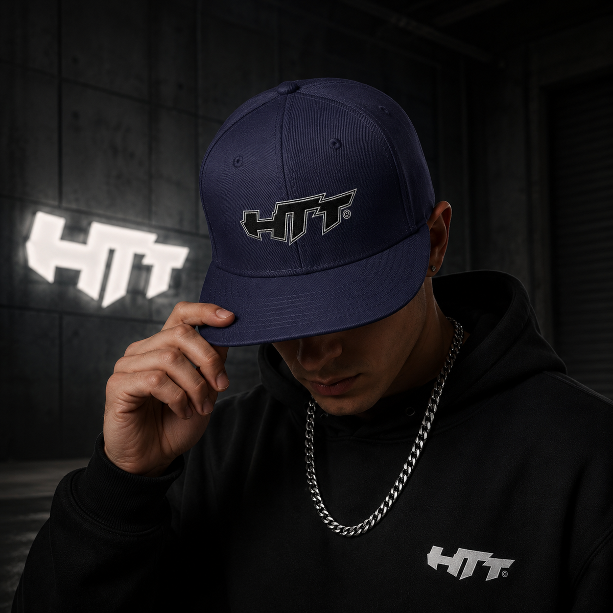 HTT Signature Snapback navy blue worn by male model with embroidered front logo