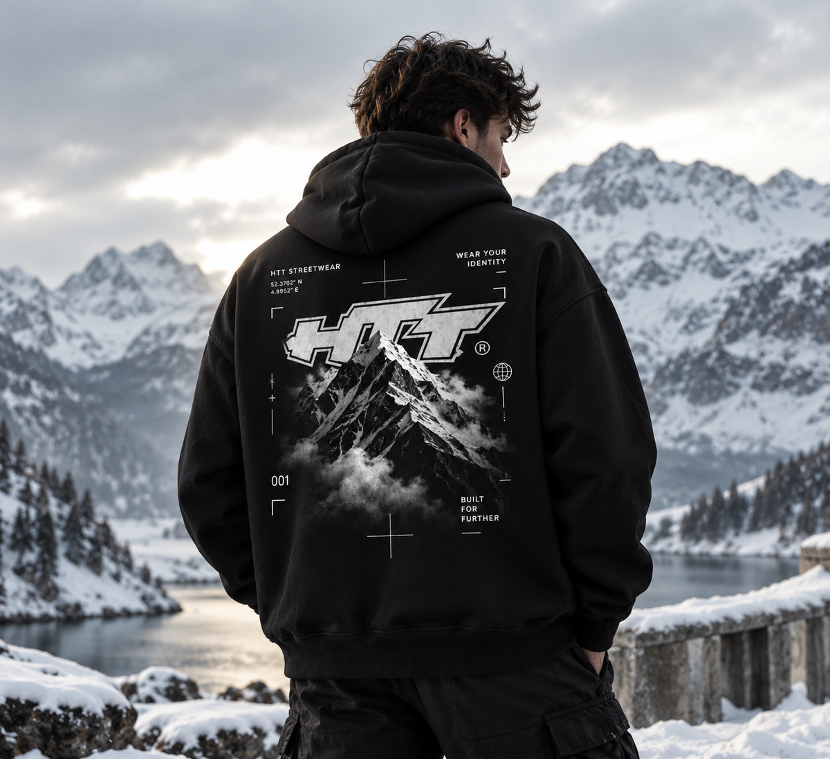 HTT.011 Mountain Peak black oversized hoodie on male model, mountain graphic back print, snowy alpine landscape