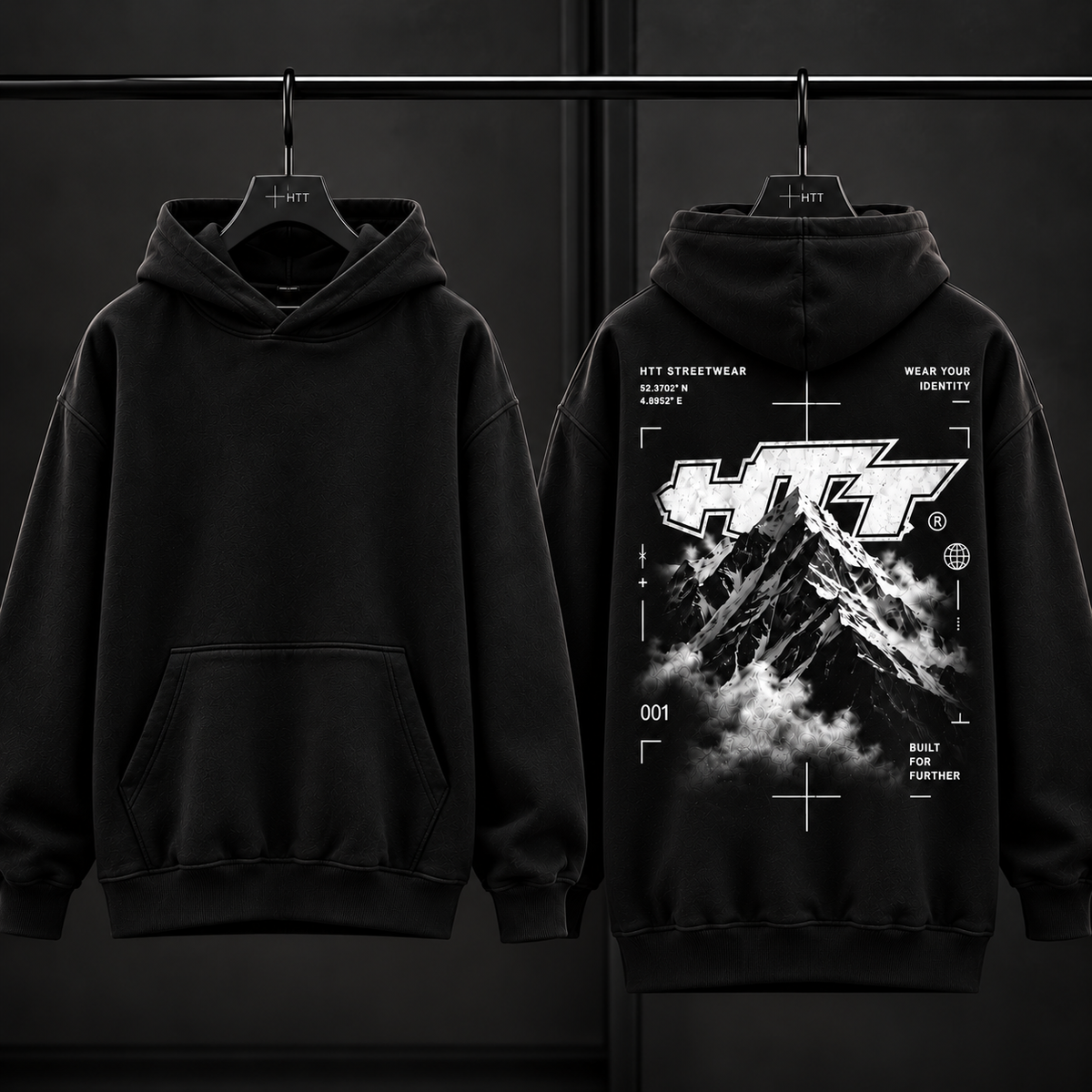 HTT.011 Mountain Peak black hoodie front and back on hangers, blank front and monochrome HTT mountain graphic on back